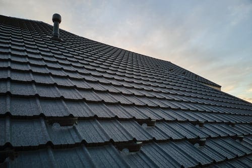 Roof coating work in progress on a Mississippi Gulf Coast rooftop