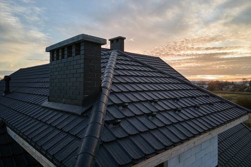 Tile roof at sunset on the Mississippi Gulf Coast, protected by a 1st Rate Roofing coating system
